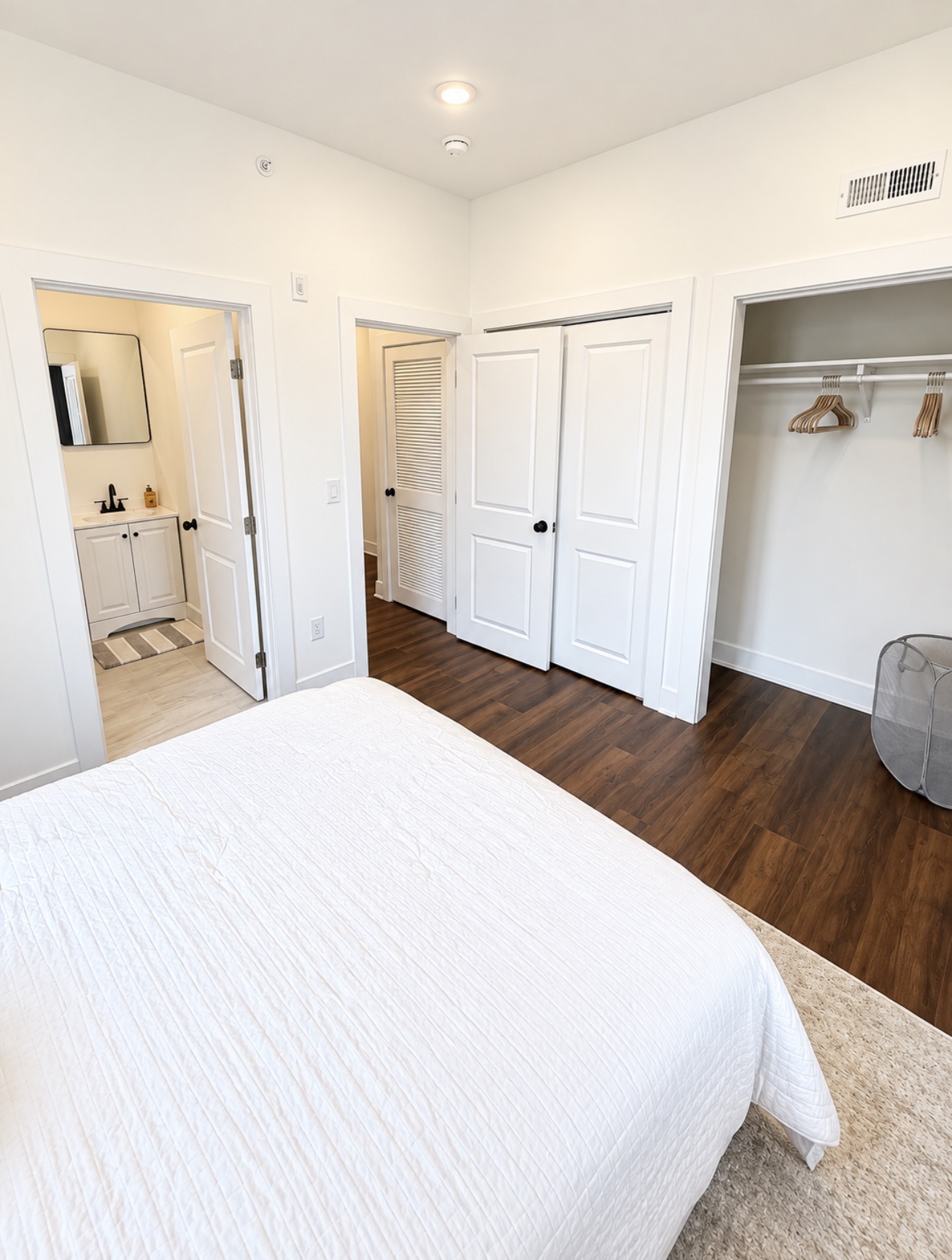 Second bedroom with closet, built-in storage and view toward the bath