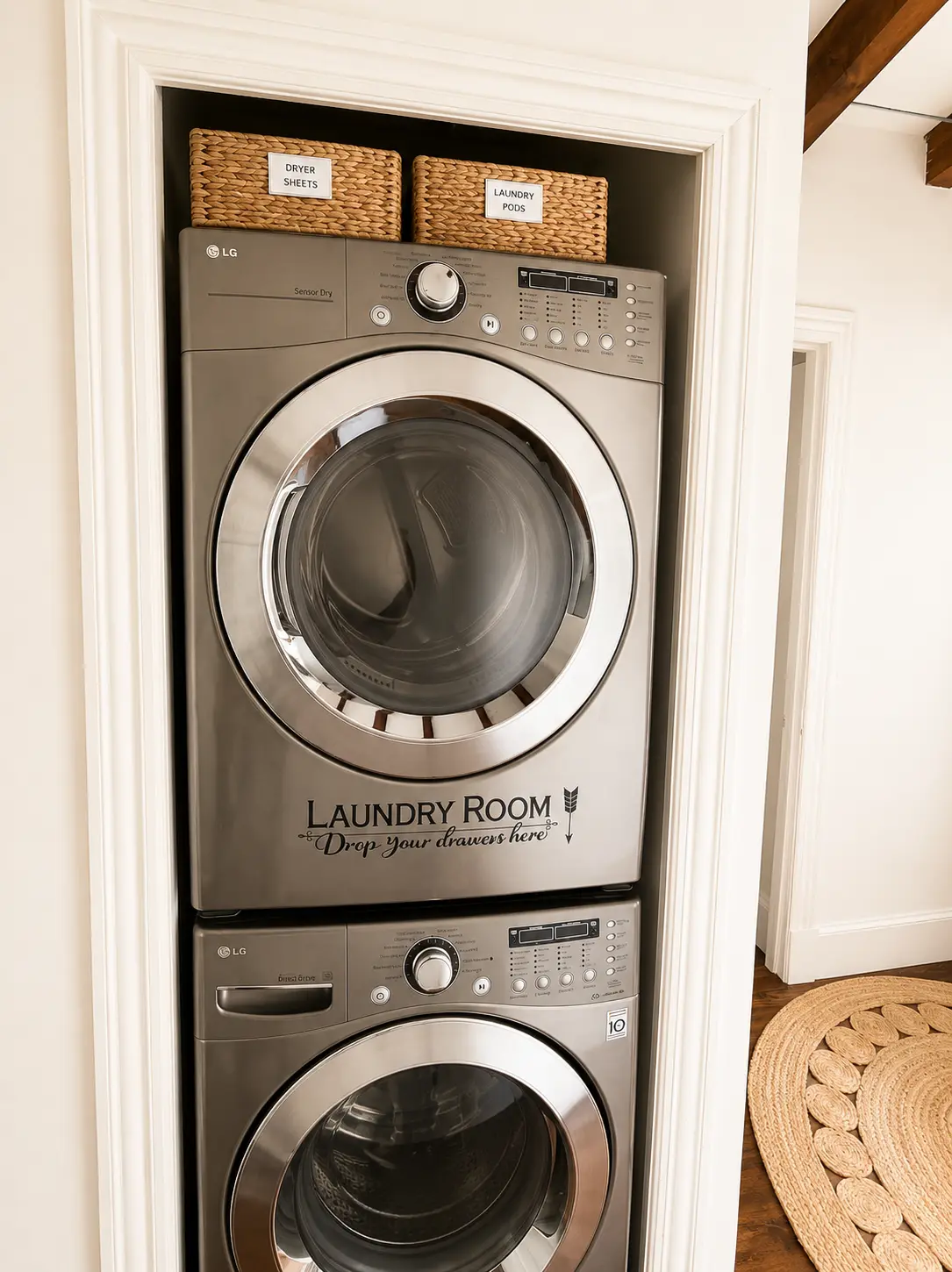 Stacked LG washer and dryer in a trimmed in-unit laundry closet