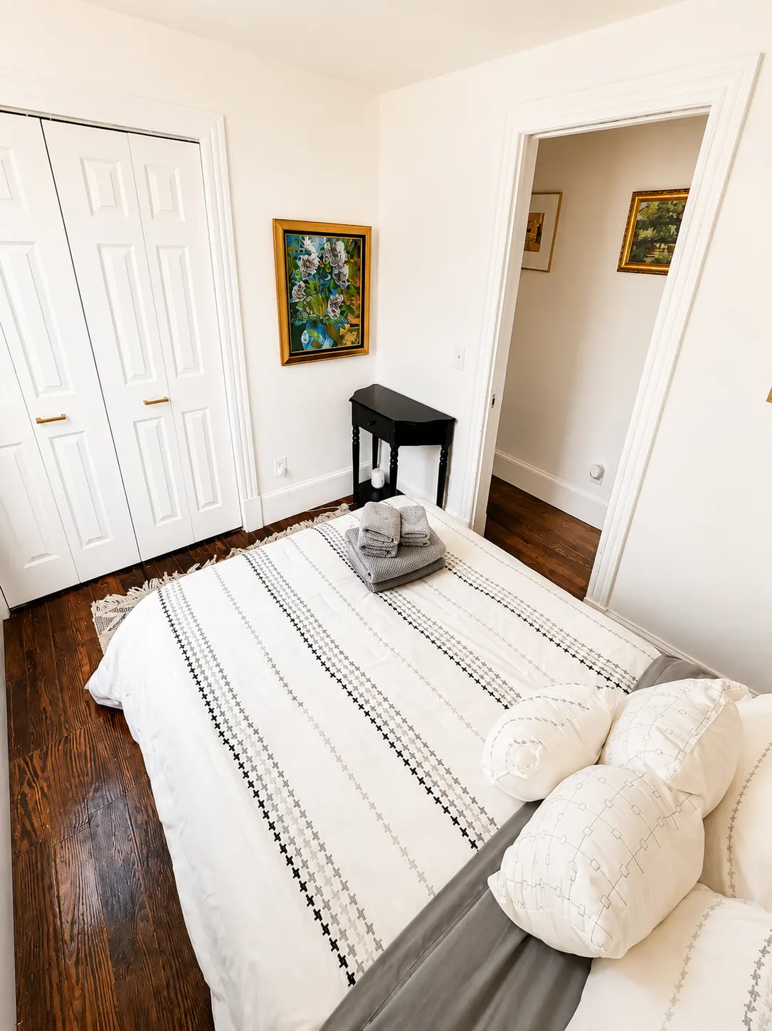 Second bedroom with queen bed, closet and hardwood floors